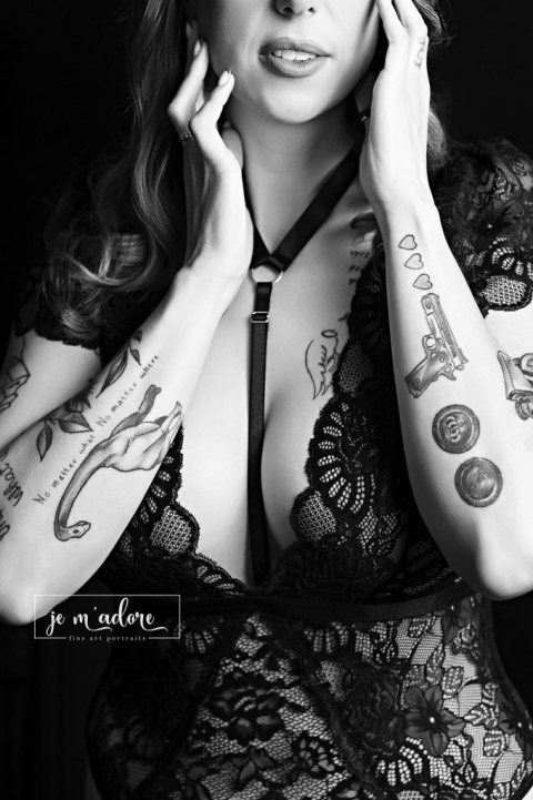 Ottawa boudoir photographer close up portrait highlighting confidence in a lace bodysuit