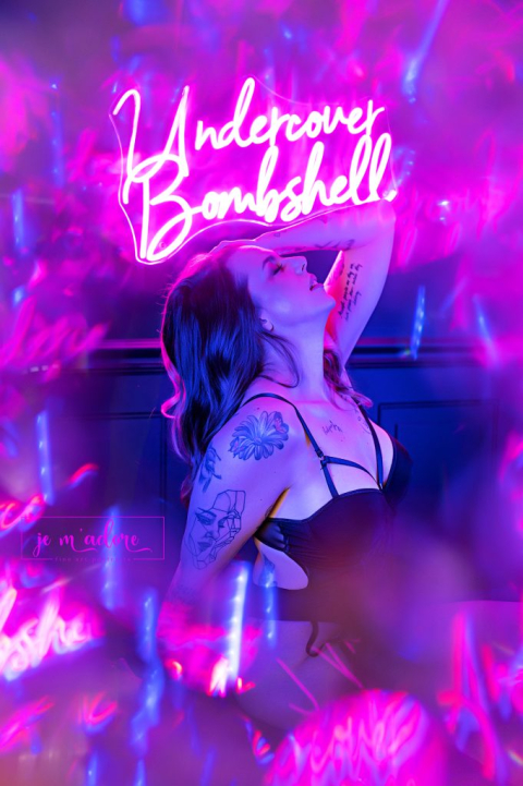 Neon lit boudoir portrait in Ottawa with vibrant lighting and bold styling
